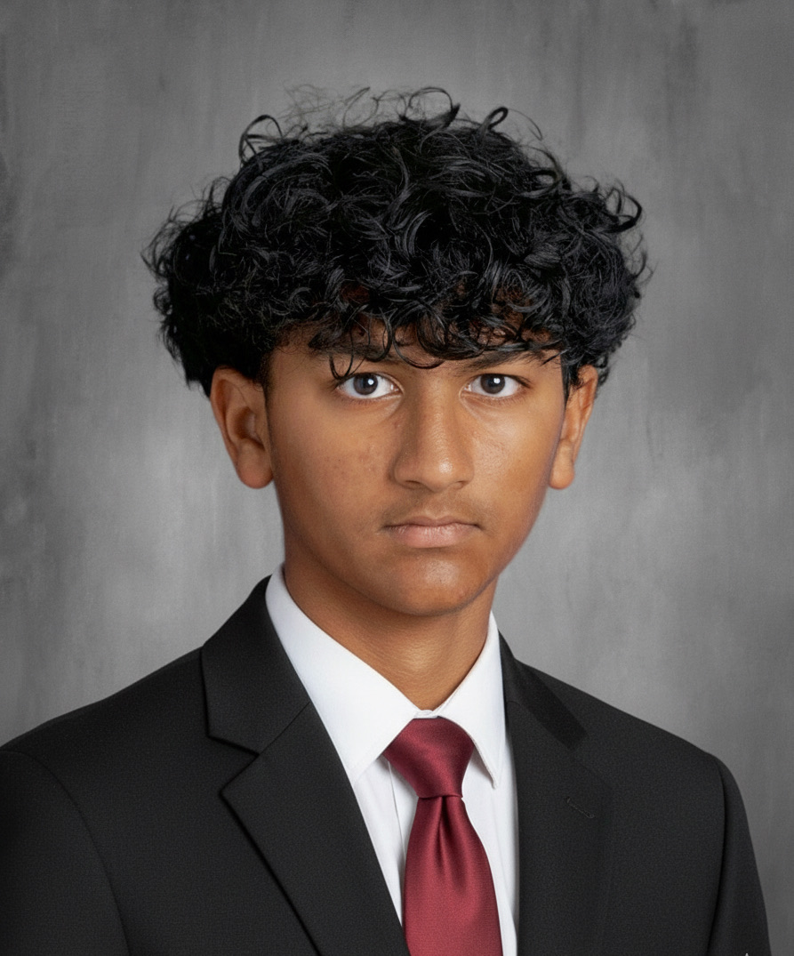 Portrait of Ritham Janardhan in a suit and red tie